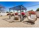 Backyard oasis featuring a pergola, cozy seating, a fire pit, and mature landscaping at 1815 N 74Th St, Scottsdale, AZ 85257