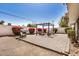 Landscaped backyard with a patio, pergola, fire pit, grill, comfortable seating, and vibrant bougainvillea at 1815 N 74Th St, Scottsdale, AZ 85257