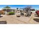 Spacious backyard with a pergola, fire pit, comfortable seating, lush plants, and stone tile at 1815 N 74Th St, Scottsdale, AZ 85257