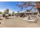 Spacious backyard featuring a gravel area, patio, pergola with string lights and outdoor kitchen at 1815 N 74Th St, Scottsdale, AZ 85257
