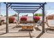 Relaxing backyard patio area with a stylish pergola, perfect for outdoor entertaining and leisure at 1815 N 74Th St, Scottsdale, AZ 85257