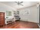 Bright bedroom with hardwood floors, natural light, vanity, storage, and ceiling fan for comfortable living at 1815 N 74Th St, Scottsdale, AZ 85257