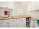 Efficient laundry room features a sink, counter space, and ample storage cabinets for organization at 1815 N 74Th St, Scottsdale, AZ 85257