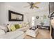 Bright living room with a large mirror, comfortable seating, and stylish decor creating an inviting atmosphere at 1815 N 74Th St, Scottsdale, AZ 85257
