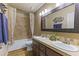 Clean bathroom with double sinks, tub shower combo, and wood vanity at 1848 E Mallory St, Mesa, AZ 85203