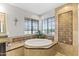 Spa-like bathroom with soaking tub, double vanity, and decorative tile at 1848 E Mallory St, Mesa, AZ 85203
