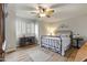 Bedroom with wood floors, ceiling fan, and antique furniture at 1848 E Mallory St, Mesa, AZ 85203
