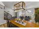 Dining area with wood floors, chandelier, and view of living room at 1848 E Mallory St, Mesa, AZ 85203