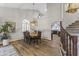 Bright dining room features hardwood floors, a chandelier, and view to kitchen at 1848 E Mallory St, Mesa, AZ 85203