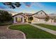 Two-story house with a landscaped yard, double garage, and walkway at 1848 E Mallory St, Mesa, AZ 85203