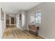 Long hallway with hardwood flooring and a drop leaf table at 1848 E Mallory St, Mesa, AZ 85203