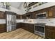 Updated kitchen with dark wood cabinets, marble countertops and stainless steel appliances at 1848 E Mallory St, Mesa, AZ 85203
