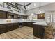 Modern kitchen with L-shaped island, stainless steel appliances, and hardwood floors at 1848 E Mallory St, Mesa, AZ 85203