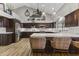 Large kitchen with dark wood cabinets, marble countertops, and stainless steel appliances at 1848 E Mallory St, Mesa, AZ 85203