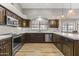 Kitchen boasts stainless steel appliances, marble countertops, and dark wood cabinets at 1848 E Mallory St, Mesa, AZ 85203