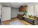 Well-equipped laundry room with wooden cabinets and a sink at 1848 E Mallory St, Mesa, AZ 85203