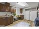Laundry room with wooden cabinets and a white refrigerator at 1848 E Mallory St, Mesa, AZ 85203