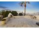 Relaxing patio area with fireplace, spa, and lush landscaping at 1848 E Mallory St, Mesa, AZ 85203