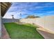 Artificial turf backyard with stone seating area at 18843 N 15Th Pl, Phoenix, AZ 85024