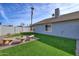 Landscaped backyard with artificial turf and stone seating at 18843 N 15Th Pl, Phoenix, AZ 85024