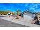 Single-story home with gray exterior, white garage door, and desert landscaping at 18843 N 15Th Pl, Phoenix, AZ 85024