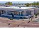 Aerial view of a complex of stucco houses with tile roofs in a desert setting at 212 E Nebraska St, Florence, AZ 85132