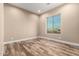 Bright bedroom with wood-look floors and large window at 22951 W La Mirada Dr, Buckeye, AZ 85326