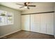 Spacious bedroom with barn-style door and wood-look floors at 236 S 2Nd St, Avondale, AZ 85323