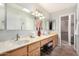 Bathroom with double vanity, large mirror, and tiled floors at 25437 S Truro Dr, Sun Lakes, AZ 85248