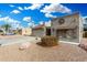 Tan stucco house with a two-car garage, mature landscaping at 25437 S Truro Dr, Sun Lakes, AZ 85248