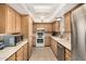 Bright kitchen with ample cabinetry, stainless steel appliances, and tiled floors at 25437 S Truro Dr, Sun Lakes, AZ 85248