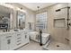 Spa-like bathroom with soaking tub, double vanity, and glass block window at 26645 N 42Nd St, Cave Creek, AZ 85331