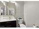 Stylish powder room with dark vanity and gold fixtures at 26645 N 42Nd St, Cave Creek, AZ 85331