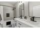 Modern bathroom with double vanity, black matte fixtures, and a bathtub at 26645 N 42Nd St, Cave Creek, AZ 85331