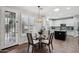 Eat-in kitchen with white cabinets, glass table, and backyard access at 26645 N 42Nd St, Cave Creek, AZ 85331