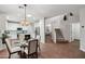 Open kitchen with island, white cabinets, and staircase view at 26645 N 42Nd St, Cave Creek, AZ 85331