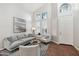 Bright living room with gray sofa, chairs, and a large window at 26645 N 42Nd St, Cave Creek, AZ 85331