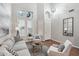 Bright living room with gray sofa, chairs, and a large window at 26645 N 42Nd St, Cave Creek, AZ 85331