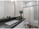 Bathroom with single vanity, black countertop and bathtub at 28813 N 201St Ave, Wittmann, AZ 85361
