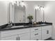 Modern bathroom with double vanity and black countertop at 28813 N 201St Ave, Wittmann, AZ 85361