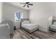Cozy bedroom with wood-look floors and a ceiling fan at 28813 N 201St Ave, Wittmann, AZ 85361
