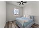 Light and airy bedroom with wood-look floors and a window at 28813 N 201St Ave, Wittmann, AZ 85361