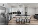 Modern kitchen with white cabinets, island, and black countertop at 28813 N 201St Ave, Wittmann, AZ 85361