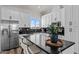 Modern kitchen with white cabinets, black countertops, and island at 28813 N 201St Ave, Wittmann, AZ 85361