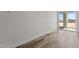 Bright spare bedroom with wood-look floors and sliding door access to backyard at 28813 N 201St Ave, Wittmann, AZ 85361
