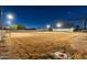 Large backyard at night with home visible in the distance at 2911 W Latona Rd # 1, Laveen, AZ 85339