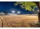 Night view of backyard, showing home and expansive grassy area at 2911 W Latona Rd # 1, Laveen, AZ 85339