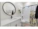 Charming bathroom with white vanity, bathtub, and floral curtain at 2911 W Latona Rd # 1, Laveen, AZ 85339