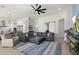 Spacious living room featuring a large sectional sofa and modern ceiling fan at 2911 W Latona Rd # 1, Laveen, AZ 85339