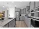 Modern kitchen with stainless steel appliances and gray cabinets at 3971 N Daisy Dr, Florence, AZ 85132